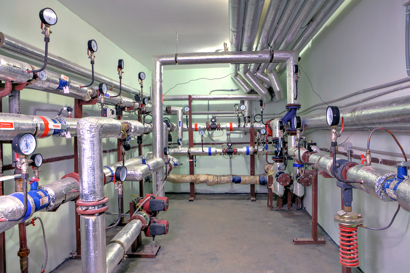 Heating system pipeline apartment house, with control and metering devices. St. Petersburg, Russia - March 5, 2013: Boiler Room in the basement of an apartment house with a heating system, manometers, pumps and metering devices.